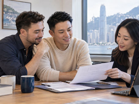 A same sex couple discussing recognised partnership documents with an adviser in a welcoming Hong Kong office