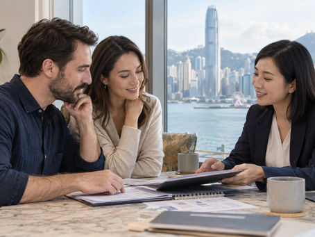 A married couple discussing dependant visa preparation with a Hong Kong adviser