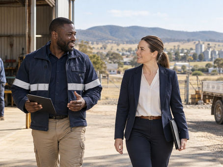 A regional employer and an overseas specialist walking through a practical Australian workplace near a small rural town in Australia