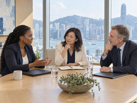A corporate HR lead, Hong Kong event coordinator and overseas specialist reviewing a workshop programme in a meeting room.