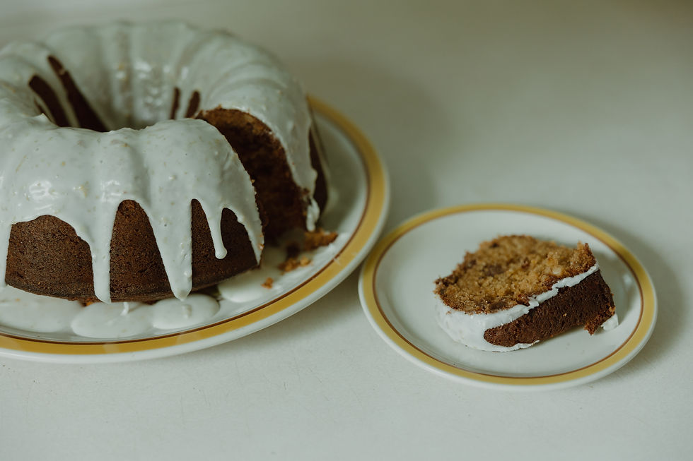 Spiced Beet Cake with Citrus Glaze - a bundt cake with white glaze on a plate; one piece is cut and served on a plate on the side