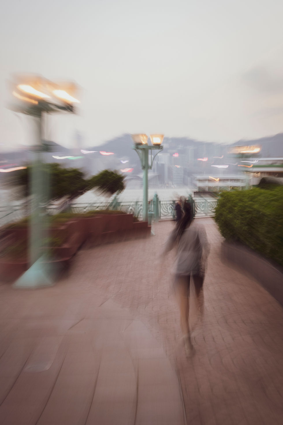 Blurred shot of a girl running on a pedestrian walkway in Hong Kong