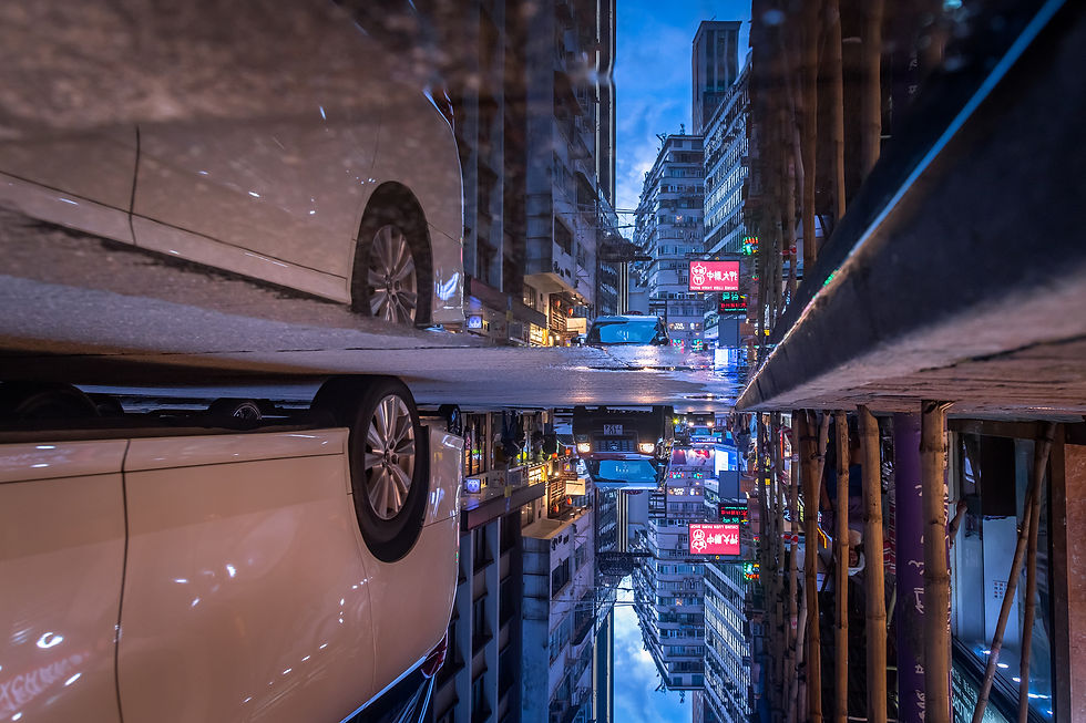 View of a car passing near a puddle on a streert in Hong Kong