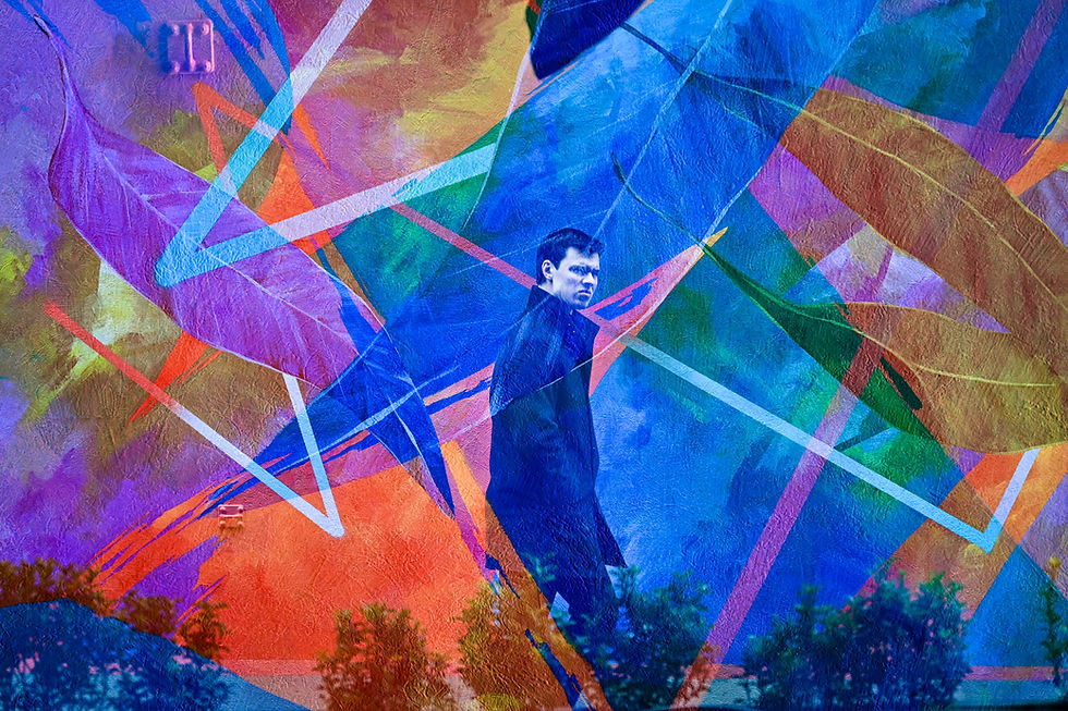 Double exposure shot of a man passing by a graffiti wall in Melbourne