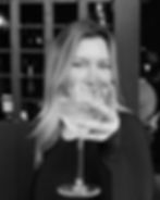 Portrait of Maddie enjoying a glass of wine, the founder and lead MedSpa website designer