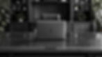 black and white photo of a laptop sitting center of a mahogany desk. This all takes place