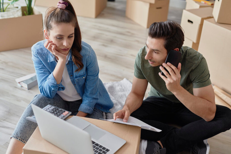 a man and a women in front of a laptop