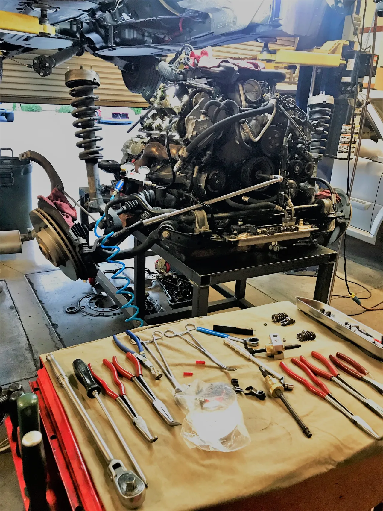 Existing repair-gallery photograph showing a removed engine assembly in the workshop.