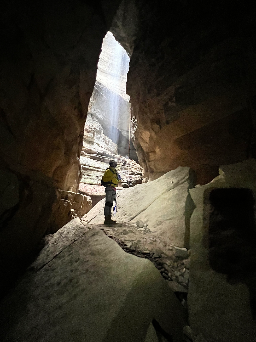 Peter Kelly leading a team on a rappelling expedition in the mountains of northern Alabama.