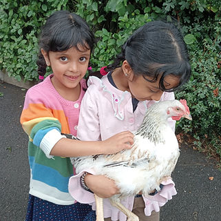 Children and one of our chickens