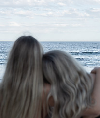 girls overlooking the sunset on the beach