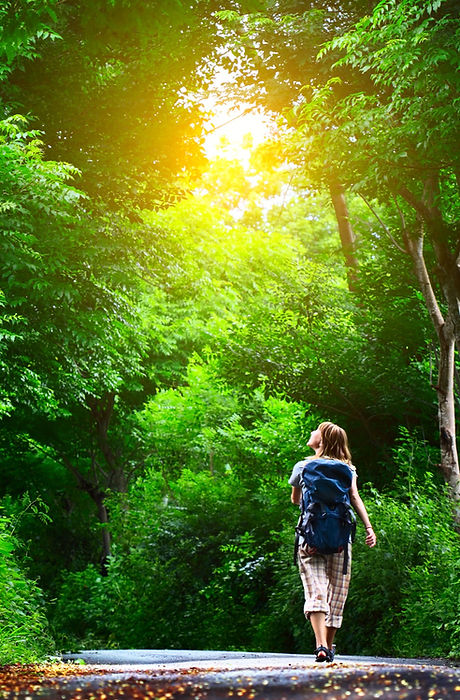 Young%20woman%20walking%20on%20green%20asphalt%20road%20in%20forest_edited.jpg