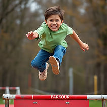 10 year old child, smiling brightly, while vaulting over a parkour obstacle.jpg
