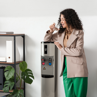 Woman using an Aquapoint 60B water cooler