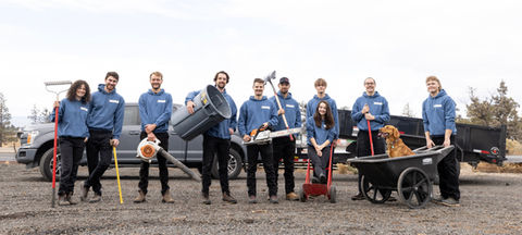 Golden retriever in wheel barrow. Team photo