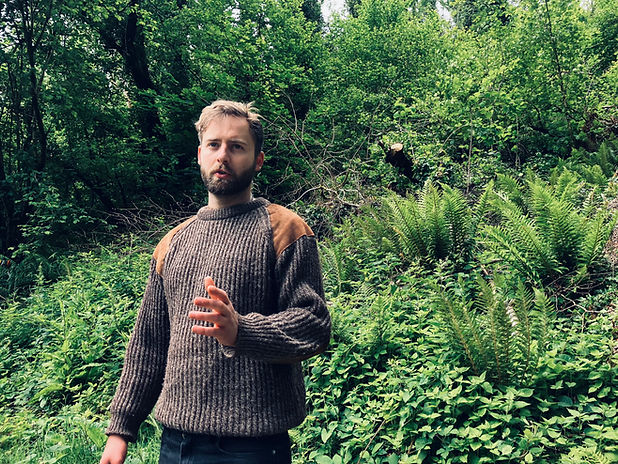 Callum Arvidsson giving a talk in a woodland