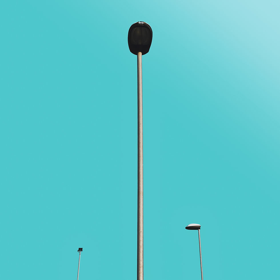 Tall streetlights stand against a clear cyan sky. Minimalistic composition with bright background.