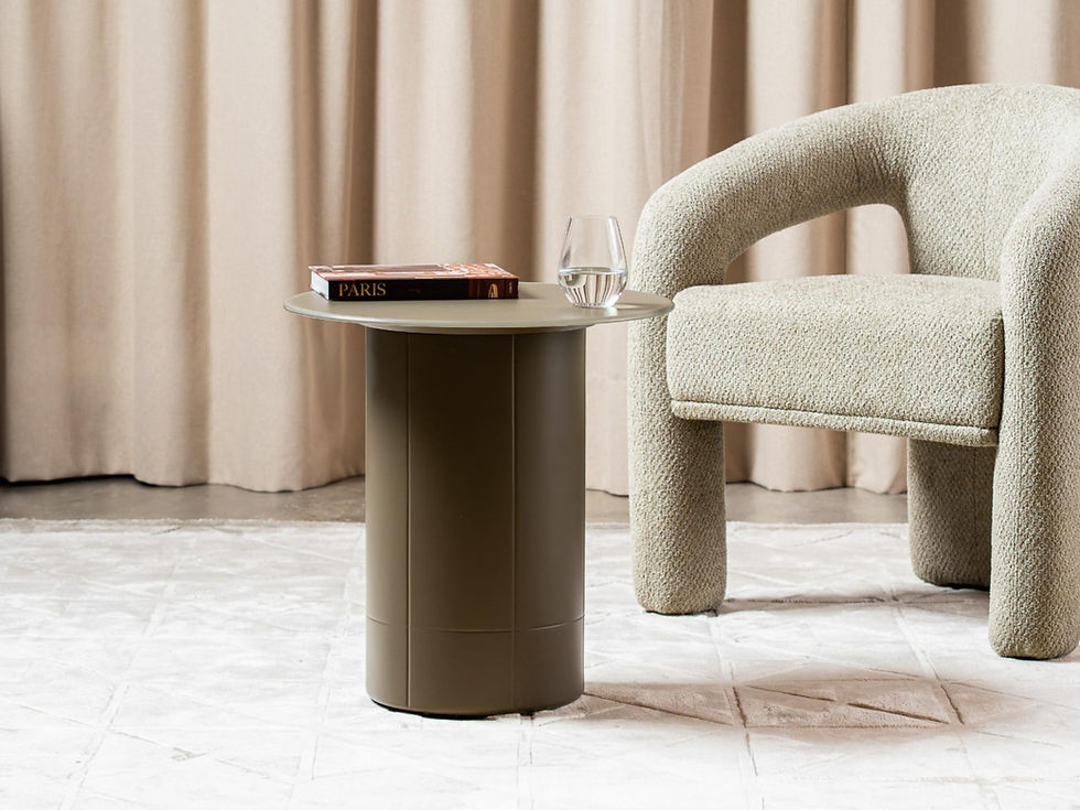 Cresswell Side Table with book and glass by an armchair.
