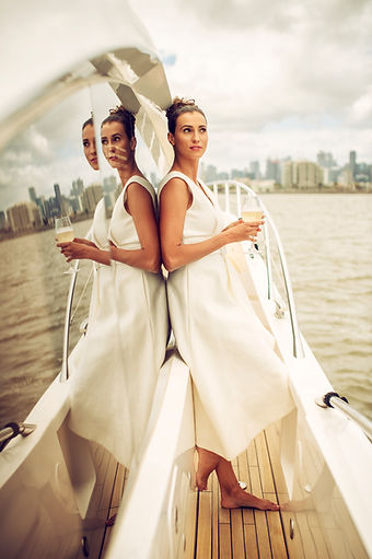Woman in white dress on boat, reflection, drink, city skyline