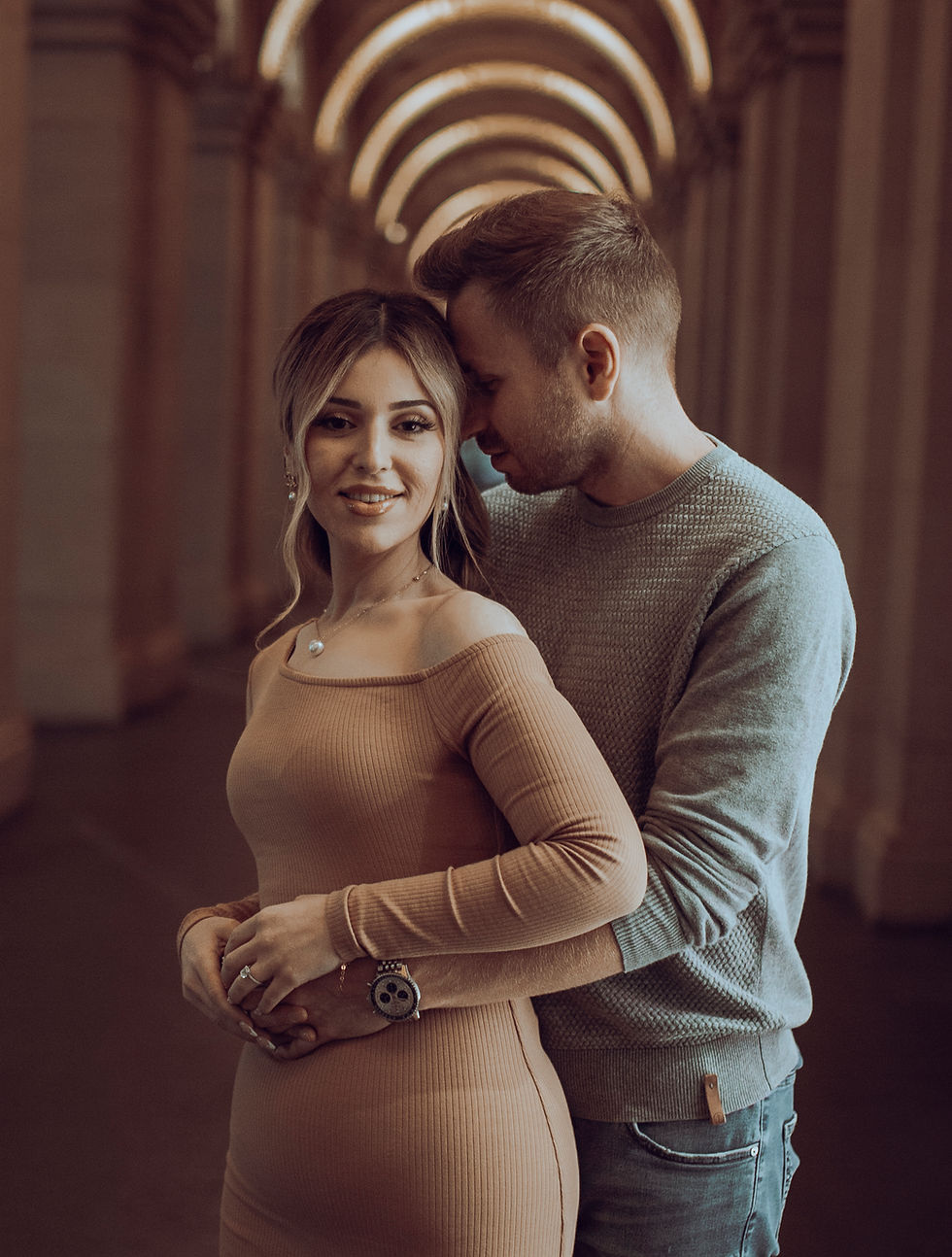 Couple together beneath an architectural archway