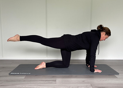Sandra performing a pilates pose