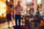 A guest singing with a microphone beside other guests at Relish in Singapore