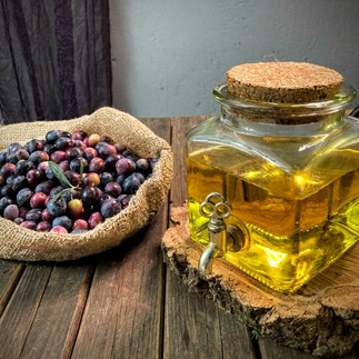 Olive oil and olives shot on a wooden surface. A healthy source of Omega 3 fats.