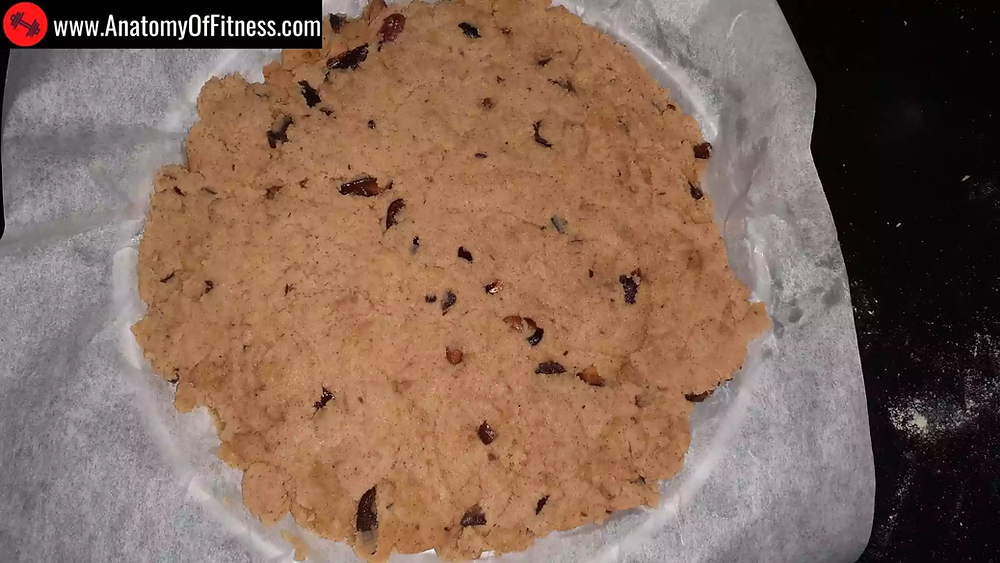 The Keto Coconut Barfi mixture spread on parchment paper.
