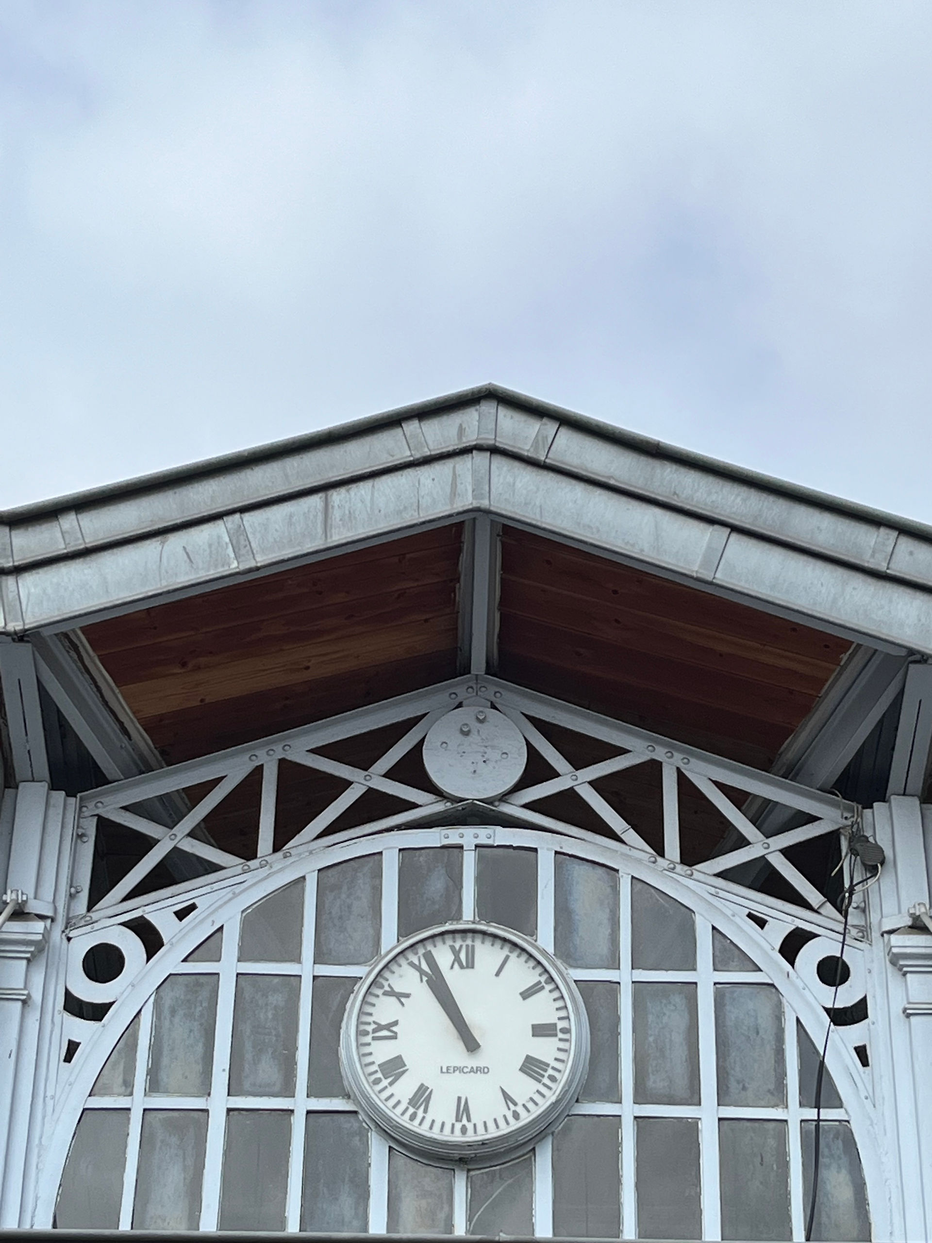A old clock above the entrance of the covered market in Toulouse.