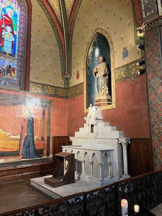 Magnificent marble altar with statue and stained-glass windows in the nave of this church in Toulouse.