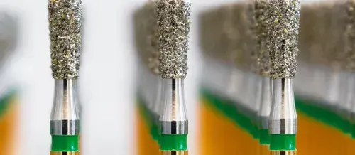 Close-up view of dental burs arranged in a tray