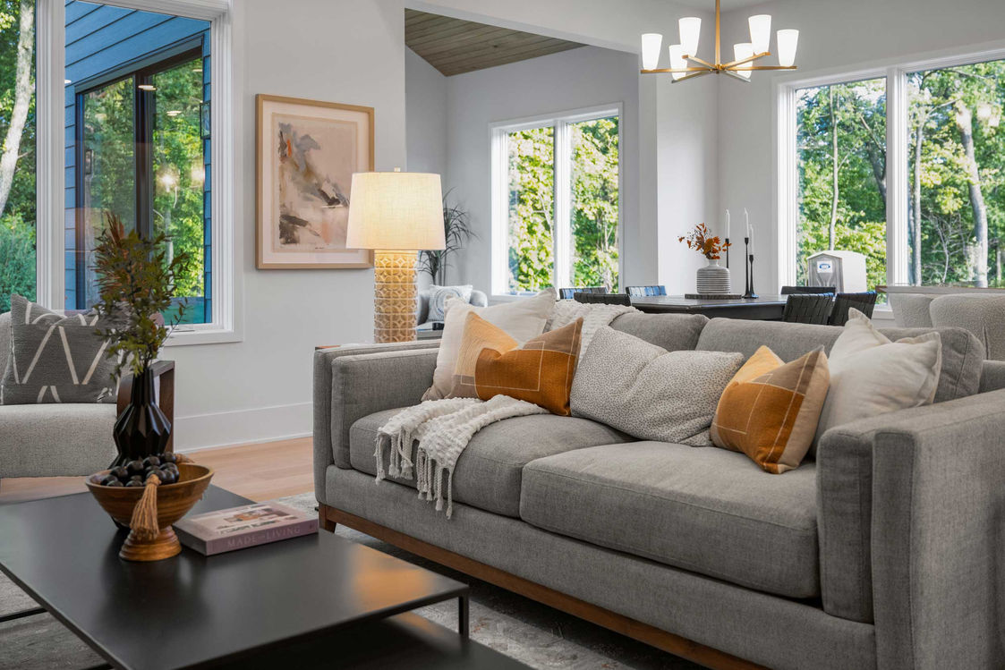Sitting room with couch in grey and bright windows