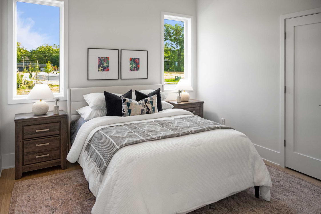 Guest bedroom in white with side table