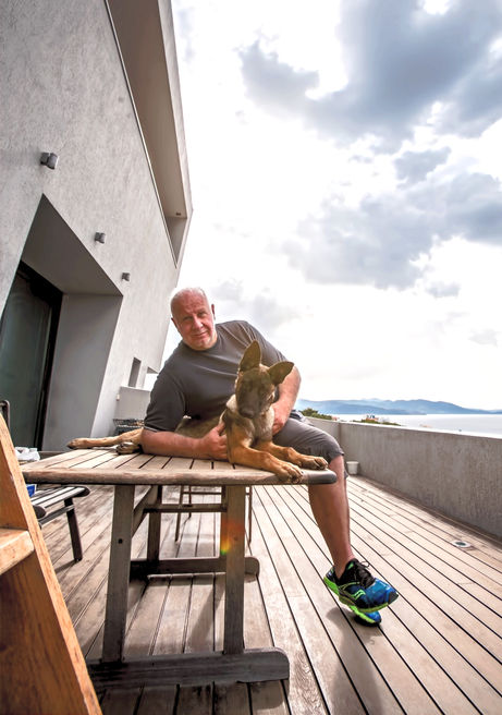 Spyros Argyropoulos sitting in the villa balcony