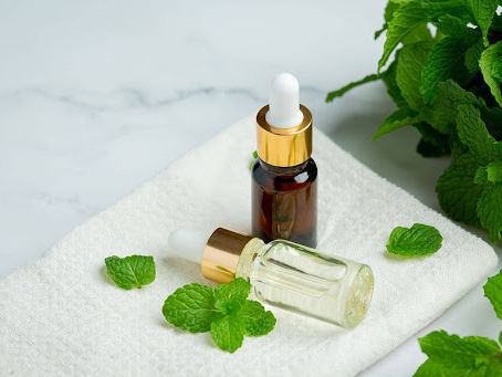 Pure menthol essential oil bottles with fresh mint leaves