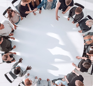 group of diverse young people at a round table meeting