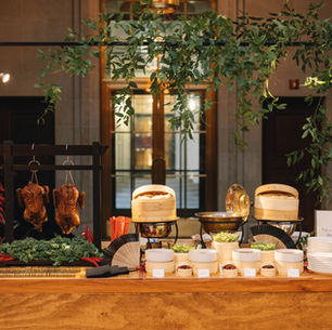 Peking Duck station on wooden table with greenery