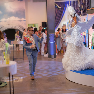 Person taking picture of swan performer