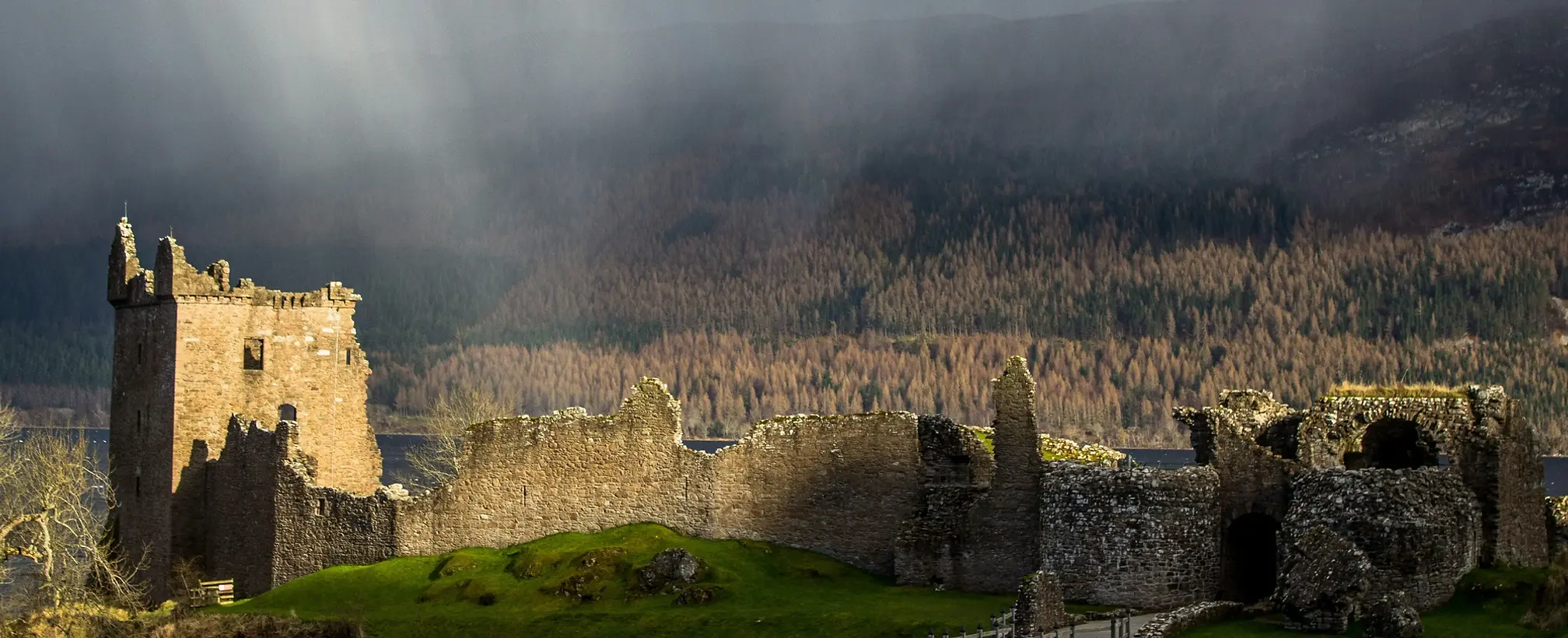 The ruins of Urquhart Castle overlooking the dark waters of Loch Ness, available on private tour from Invergordon Port for up to 7 Passengers