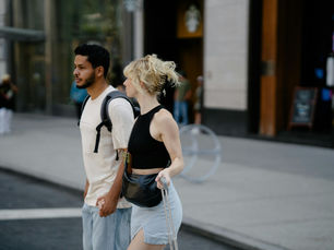 Expat couple in a new city crossing a road together