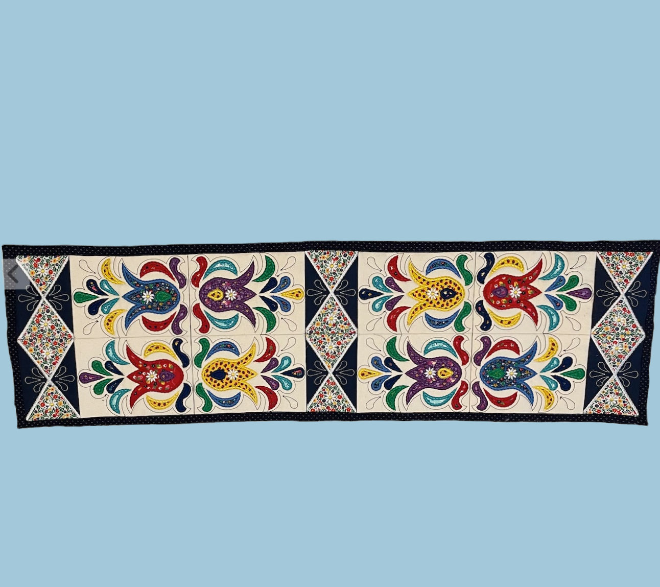embroidered table runner with pysanky pattern