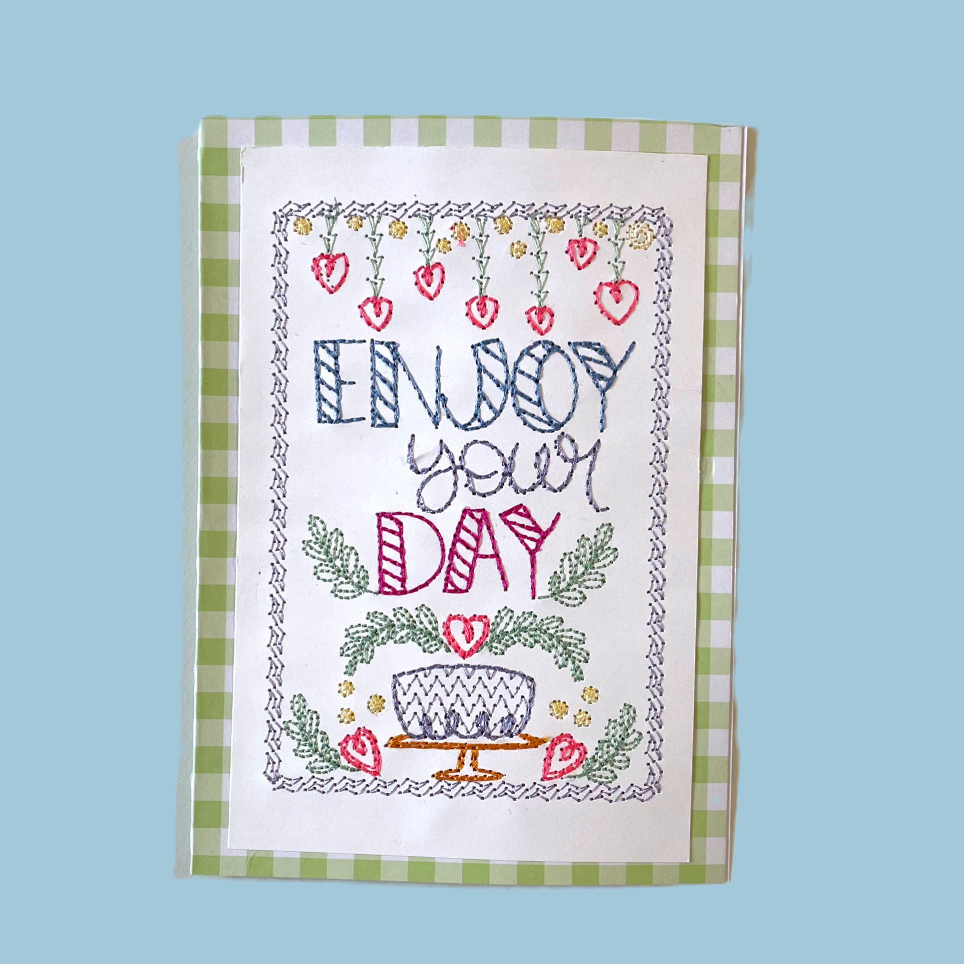 Embroidered birthday card with "enjoy your day" quote