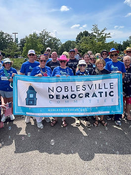 HamCo Dems continue to organize. Here’s your chance to help bring your community together for next year’s crucial midterm elections. Noblesville Democratic Committee members march in the Fourth of July parade. A Precinct Chair , or PC, is a critical position in the statewide structure of the Democratic Party in Indiana. The PC serves as the person elected or appointed to organize the voters in their own precinct, making this an official position of importance to the party. They help voters get involved, ensure that precinct positions are filled on election days, and make sure Democratic-leaning voters come out to vote. It’s a crucial role in uniting our voters and helping them work together most effectively.  New township leadership Earlier this year, Carmel PC and Clay Township Chair Susan Ring was appointed to the new position of Deputy Chair for Hamilton County’s Elections Committee. In her new role, she will be leading our county’s township leaders as they seek to appoint more PCs in their townships. Her guidance and support will give our PCs focus and networks that will ensure their success. Fishers Democratic Committee members connect with community during the No Kings protest at the Hamilton County Courthouse June 14. Precinct Chair Meetings Under Susan's direction, the townships are in the process of having a series of meetings where they’ll discuss what PCs do and help get new and aspiring PC up and running, as well as re-inspire current PCs. Carmel’s meeting will be Sunday, August 3, at 2pm at the Carmel Clay Public Library (sign up here ).  Noblesville’s meeting will be Thursday, August 14, at 7pm (sign up here ). For anyone in the county who missed their township’s meeting, there will be another PC meeting on August 27 at 6pm at the Carmel Clay Public Library (signup link to come). Fishers and Westfield had their meetings earlier in July, and attendees agreed they were a big success. “What an excellent and organized meeting for both curious and existing precinct chairs,” said one Fishers attendee. “Everyone cares so much.”  Boots on the ground The 2026 midterm elections are coming more quickly than you may think, and candidates on the opposing side who can see the wind blowing against their party's irresponsible and harmful decisions are assembling their troops now for an intense contest. Meanwhile, Democrats across Hamilton County are feeling the groundswell of excitement around our party. We are seeing growing attendance at events. We're hearing louder support at protests and celebrations. We're fielding increases in donations to both local party committees and the state party. And most importantly, we're encountering more openness to our principles and ideas in public discourse. We are hungry to win, but we need your boots on the ground to march us forward! When we share in the work, we accomplish more together. We hope we'll see you at an upcoming PC meeting, where we can direct your energy into real action that helps us win elections.