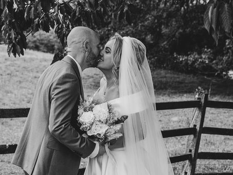 Newly wed husband and wife embrace after their ceremony