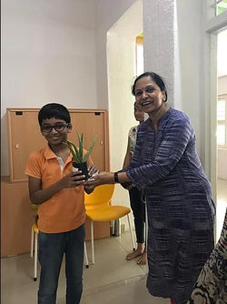 Smita ma_am giving away herbal saplings.