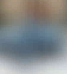 Model in gray suit and black block heel boots by Vivien Lauren