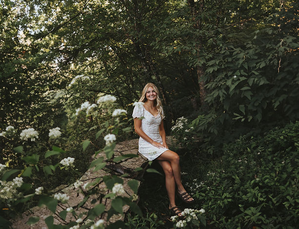 Girl smiling surrounded by greenery