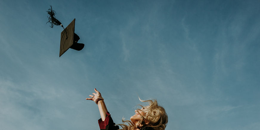 graduate throwing cap in the air