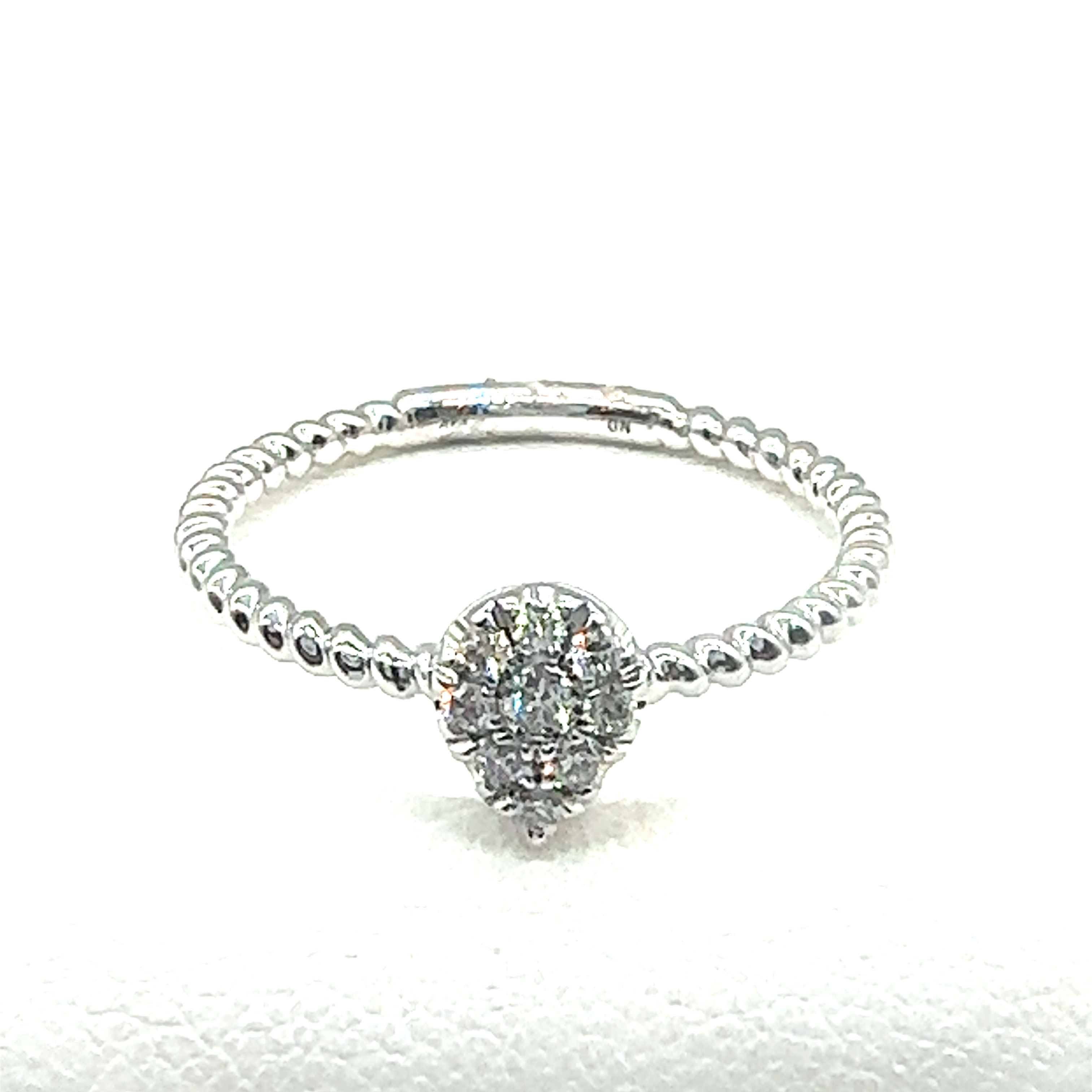 Elegant ring with small diamonds. Emerald Halo Diamond Ring. Ronnie's Jewelry.