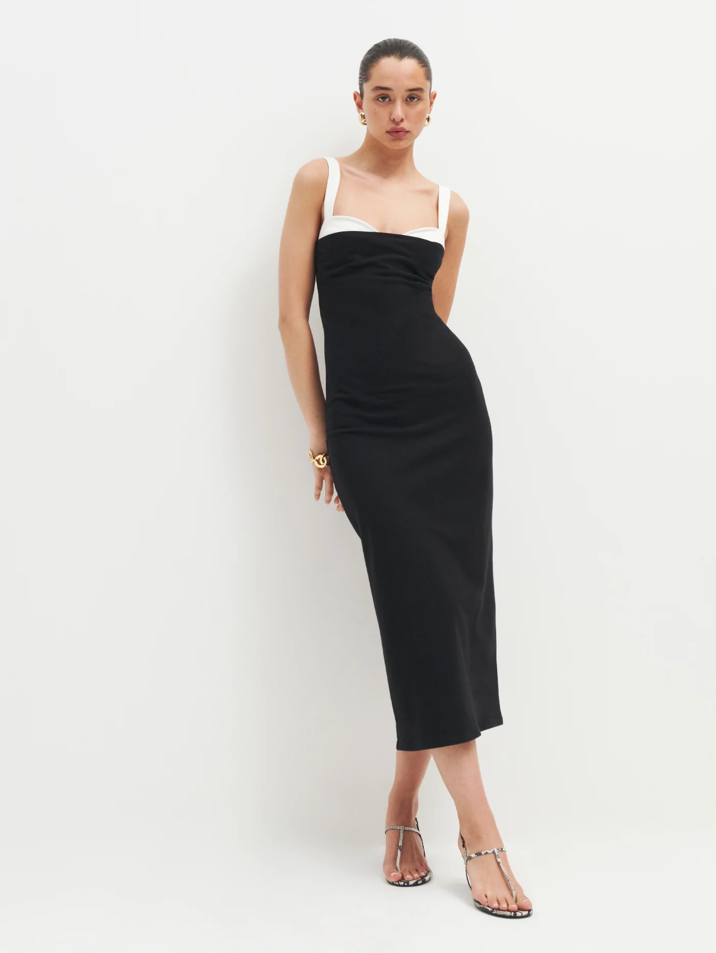 a wonen wearing a black dress with white bra attached to dress 